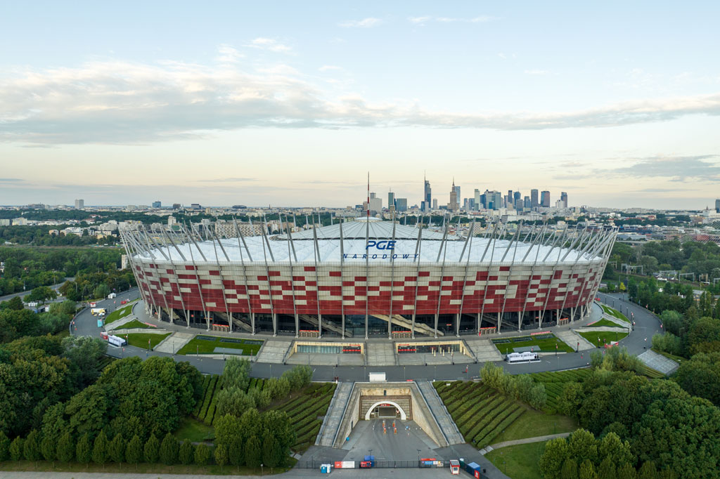 Top view of the PGE National Stadium, from the side of Aleja Zieleniecka, in the background the center of Warsaw, greenery all around, day, summer.